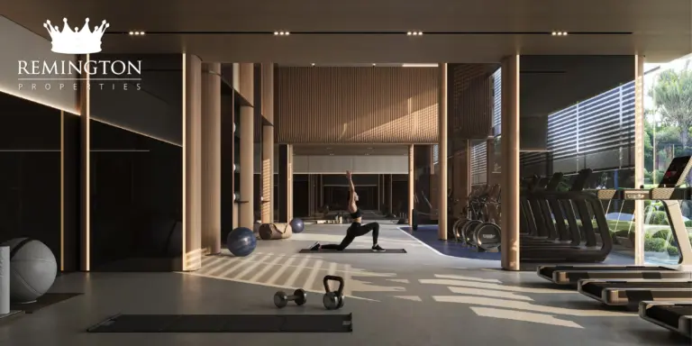 Indoor fitness centre with cardio equipment and yoga space at Binghatti Starfall