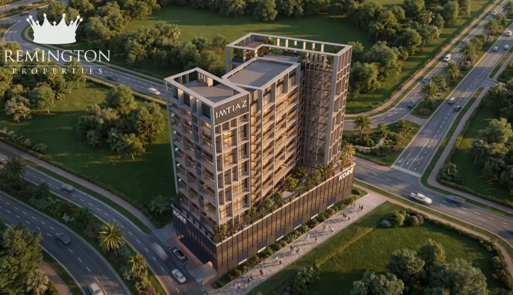 An elevated dusk view of the KORE by Imtiaz tower, roof terraces, trees and surrounding roads.