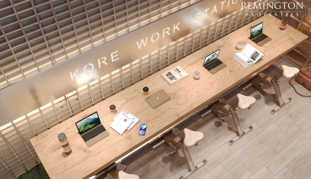 A long shared work counter at KORE by Imtiaz, with stools, desk lamps and KORE WORK STATION lettering.