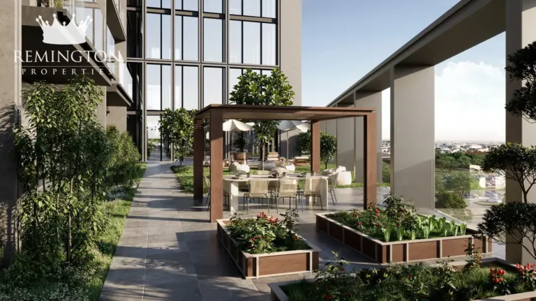 Architectural rendering of a landscaped courtyard between KORE by Imtiaz buildings, with a covered walkway, planted beds and seating.