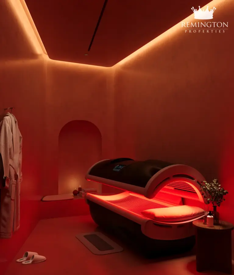 Interior rendering of a red-lit wellness room with a therapy pod and warm accent lighting.