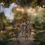 A family walking along an illuminated forest path.