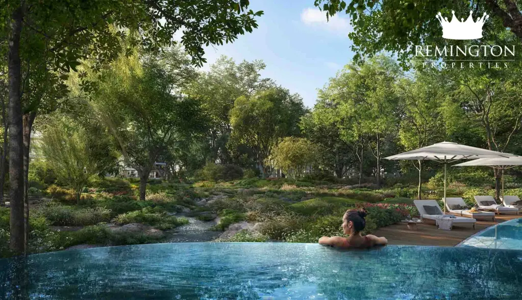 A swimming pool and shaded loungers surrounded by greenery.