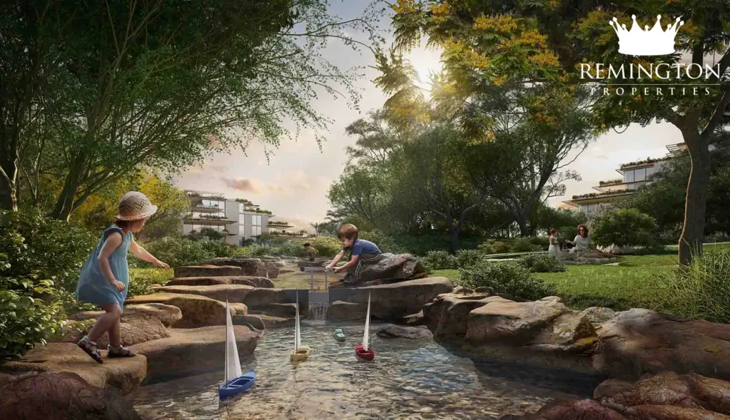 Children playing beside a landscaped stream and rocks.