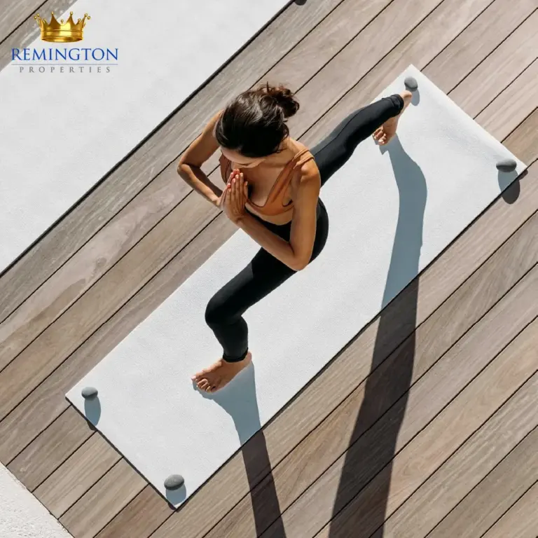A resident practises yoga on a mat in an outdoor wellness space.