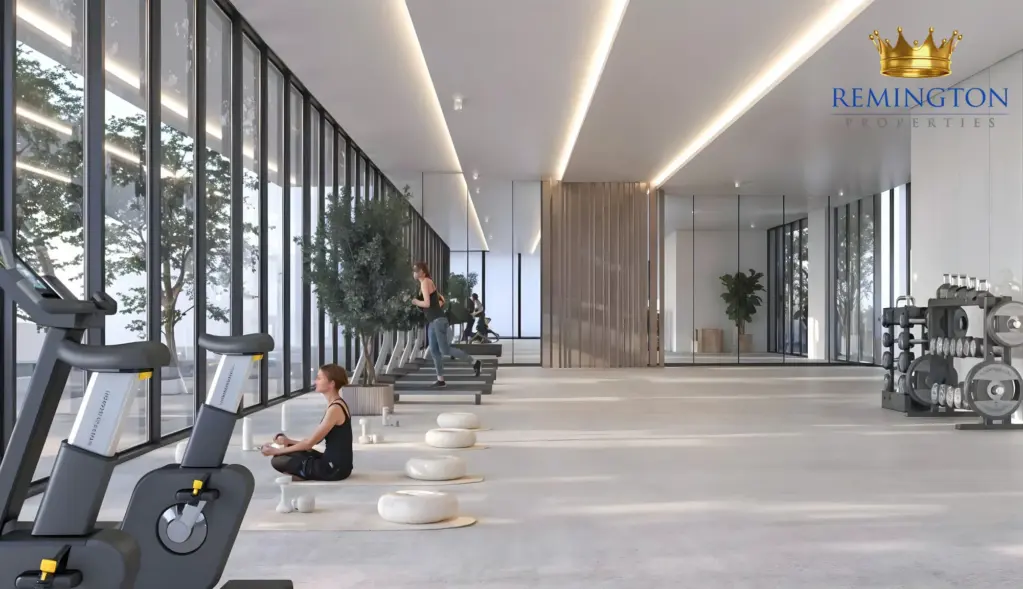 Fitness room with cardio equipment beside full-height windows