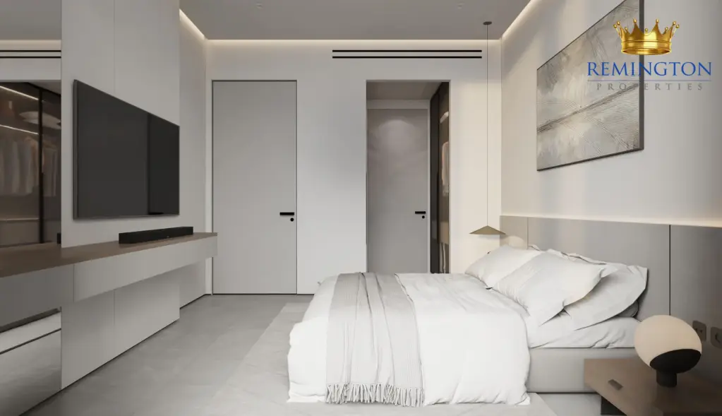 Bedroom with built-in wardrobes and a wall-mounted television