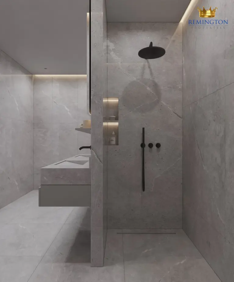 Walk-in shower and stone-finish vanity in a two-bedroom home