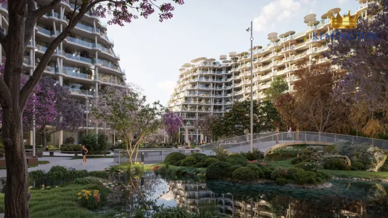 Garden bridge and pool framed by flowering trees and residences