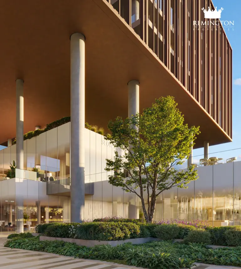 Vertical view of bronze-toned façade louvers, a supporting column and landscaped paths