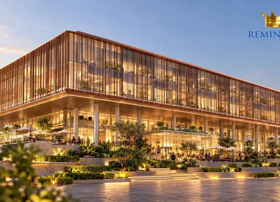 Commercial building with bronze-toned louvers, illuminated glazing and landscaped arrival steps at dusk