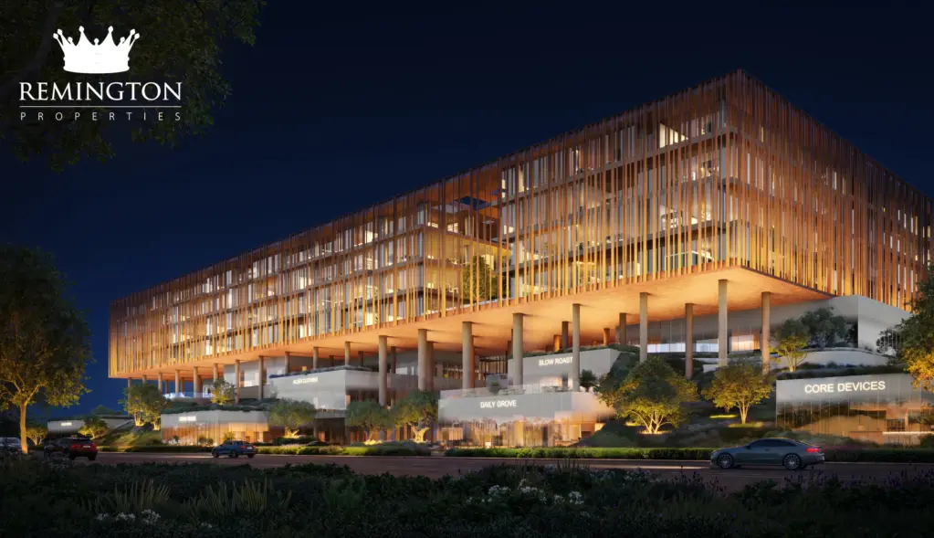 Yards Plaza office building illuminated at night above landscaped pedestrian and arrival areas