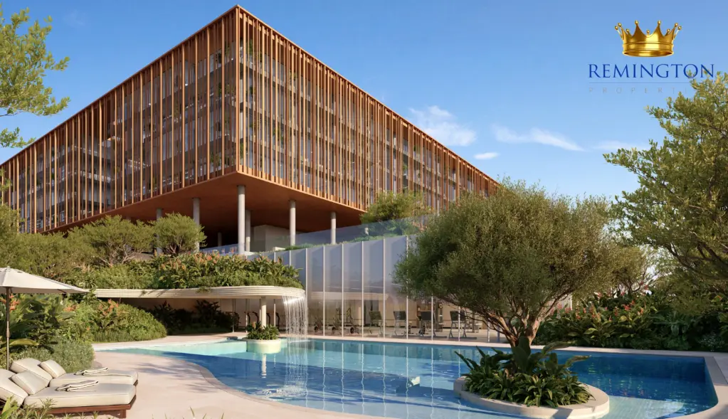 Swimming pool beside landscaped seating and the bronze-toned commercial façade