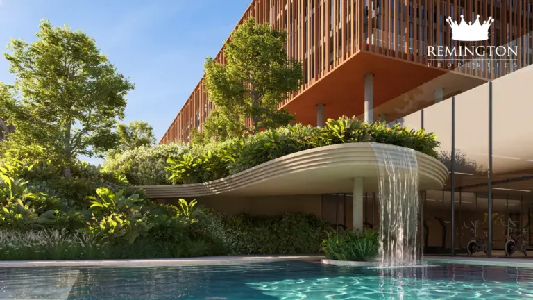 Poolside terrace with curved edges, planting and an elevated glazed building